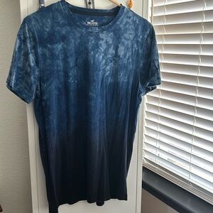 Hollister. Medium. Blue fade to lighter blue. T-Dye like pattern. Crew neck tee.